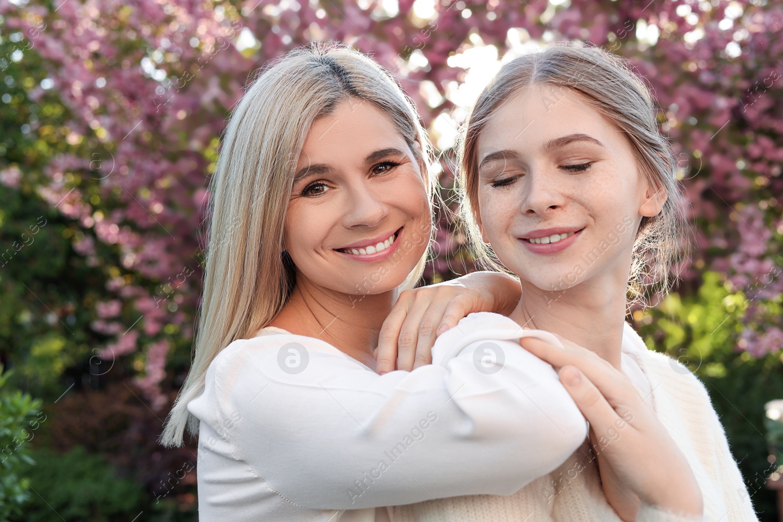 Photo of Happy mother with her daughter spending time together in park on sunny day