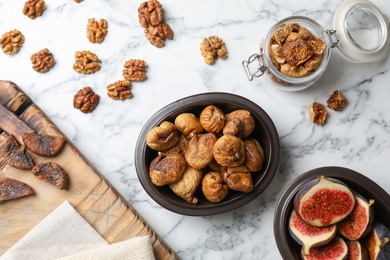 Photo of Flat lay composition with walnuts, fresh and dried figs on marble background