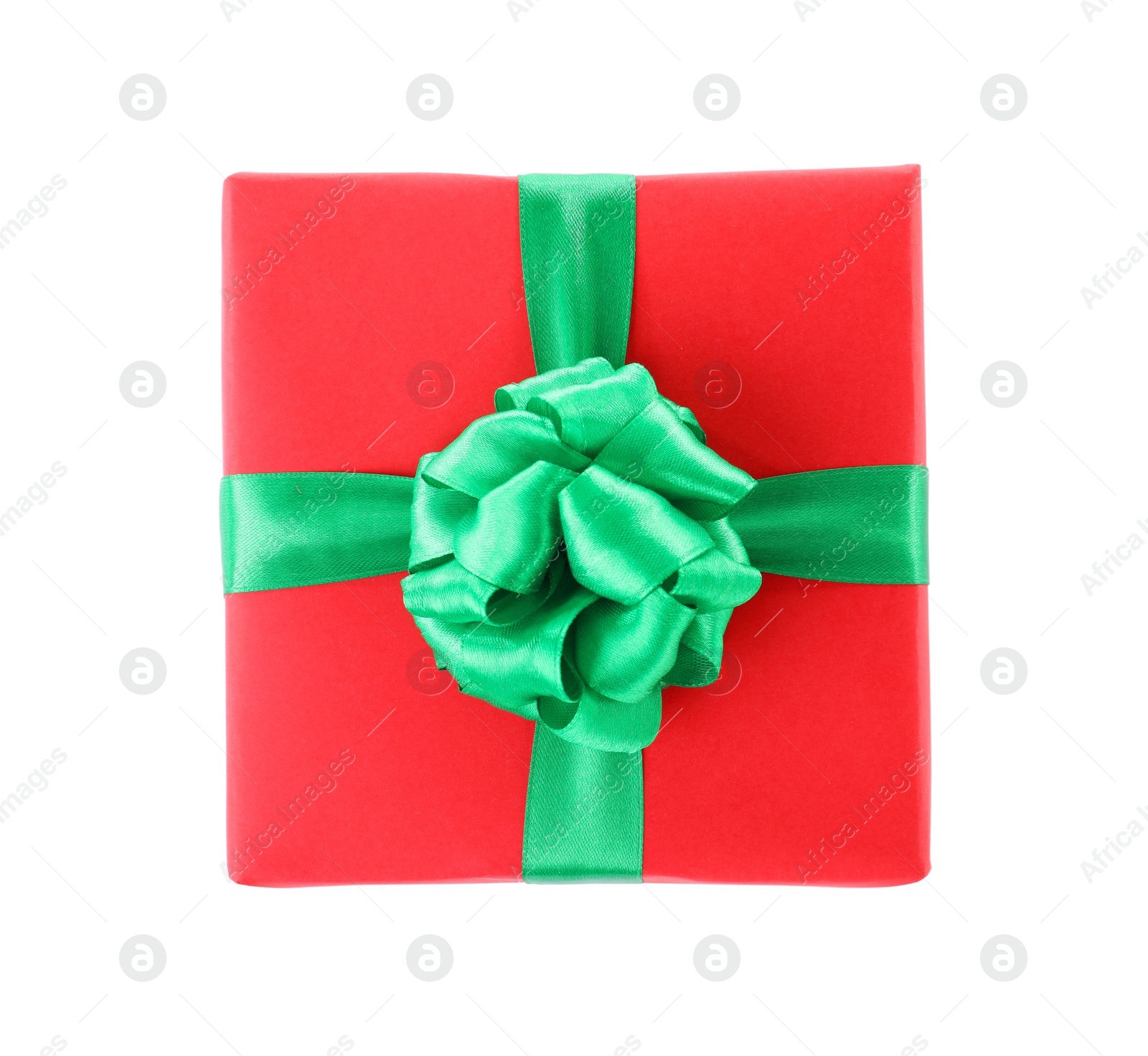 Photo of Christmas gift box decorated with ribbon bow on white background, top view