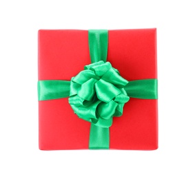 Photo of Christmas gift box decorated with ribbon bow on white background, top view