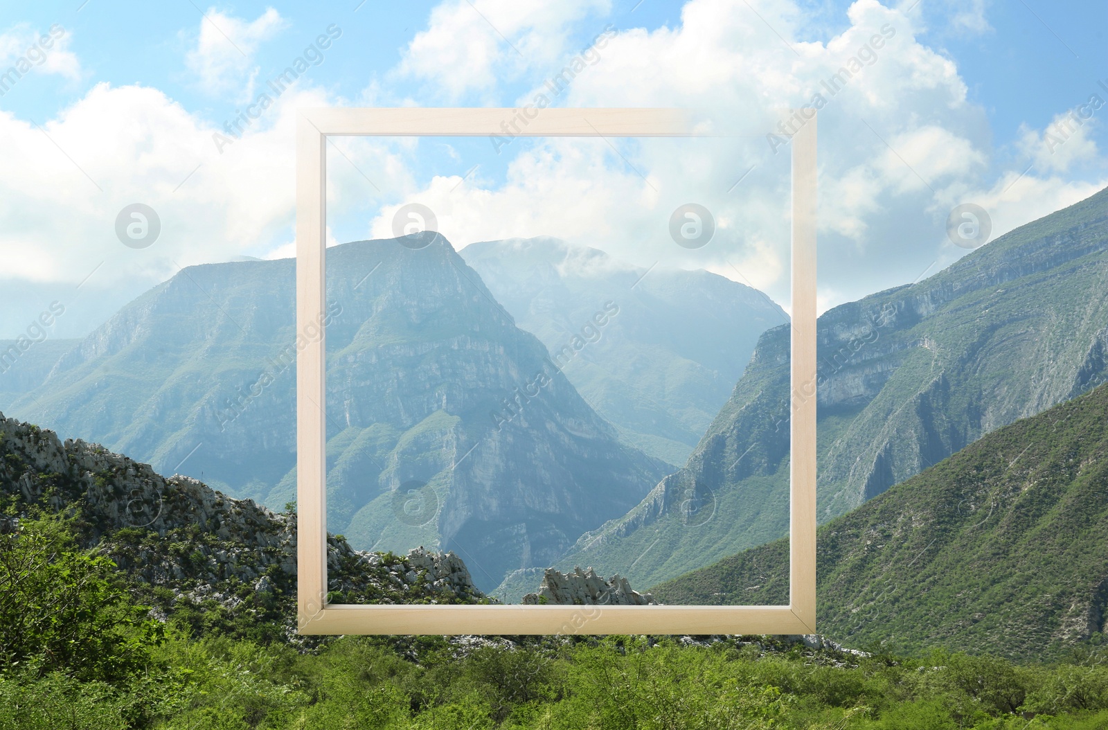 Image of Wooden frame and beautiful mountains under blue sky with clouds