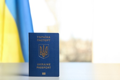 Ukrainian travel passport on table against blurred background, space for text. International relationships