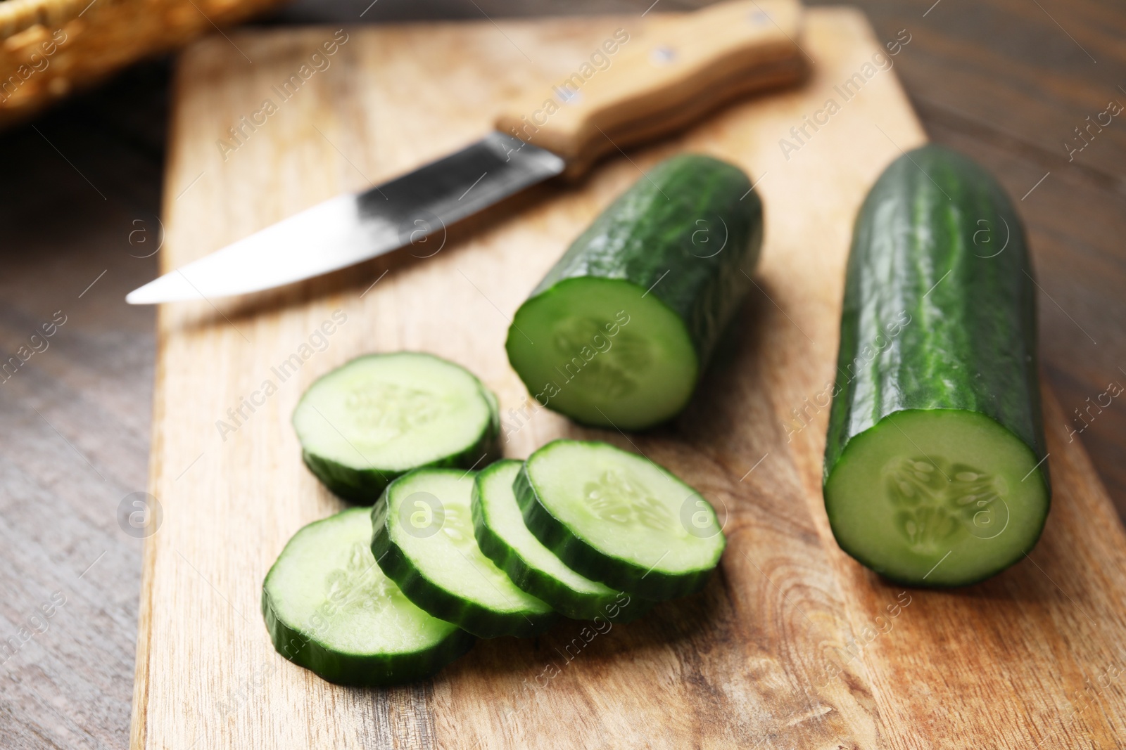 Photo of Fresh cut cucumber on wooden table, closeup