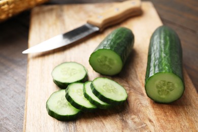 Photo of Fresh cut cucumber on wooden table, closeup