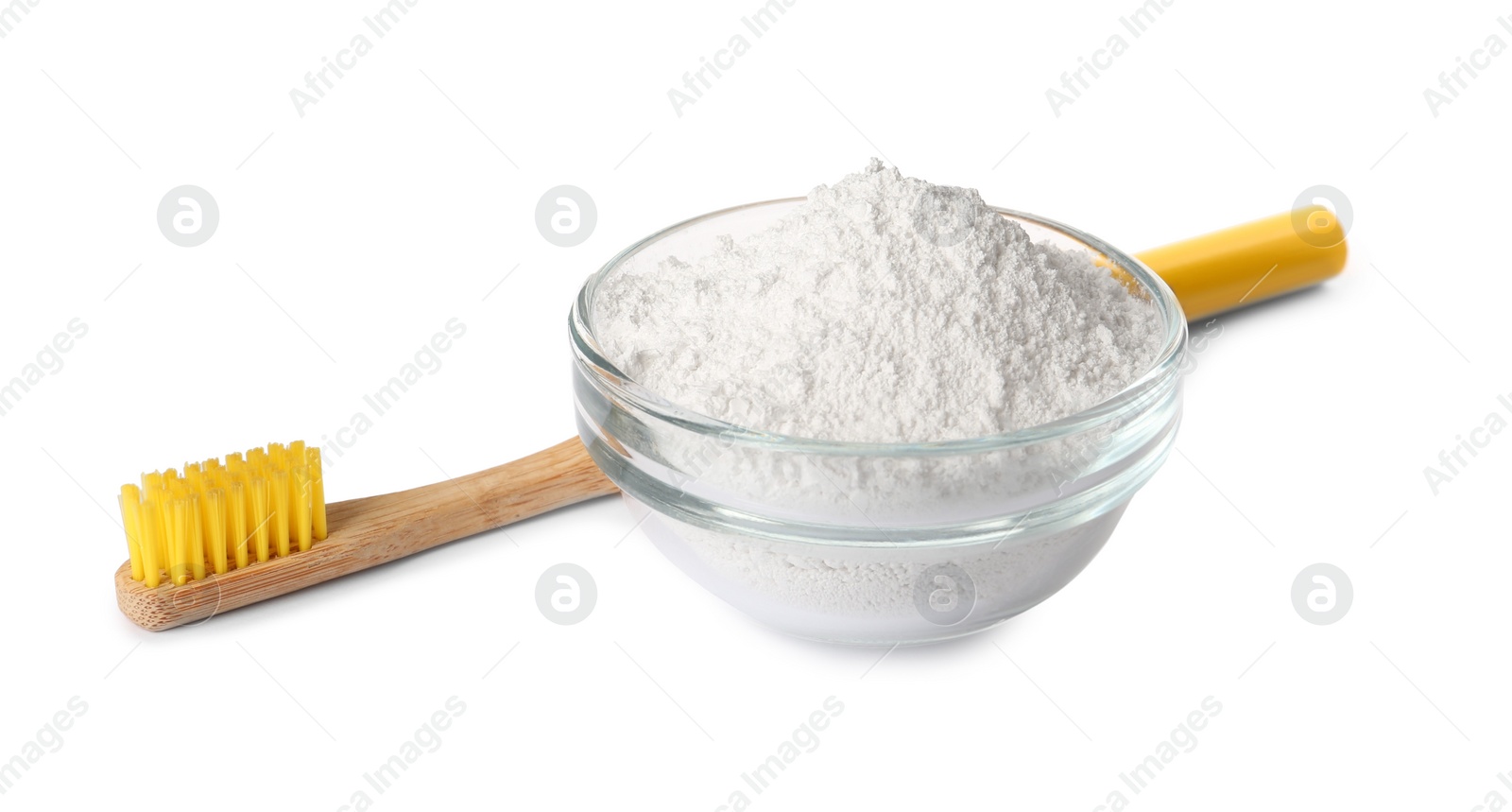 Photo of Glass bowl of tooth powder and brush on white background