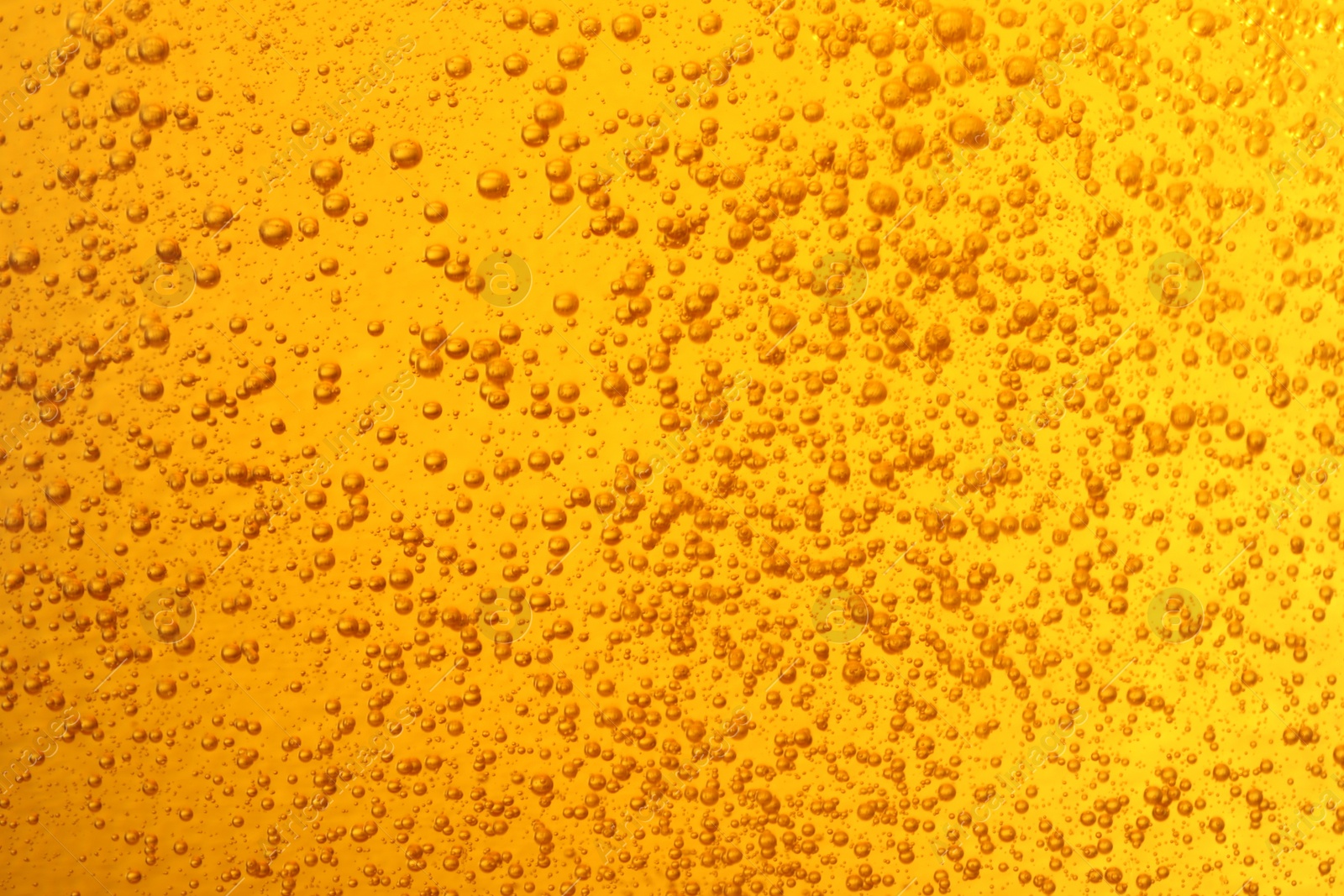 Photo of Tasty beer with bubbles as background, closeup