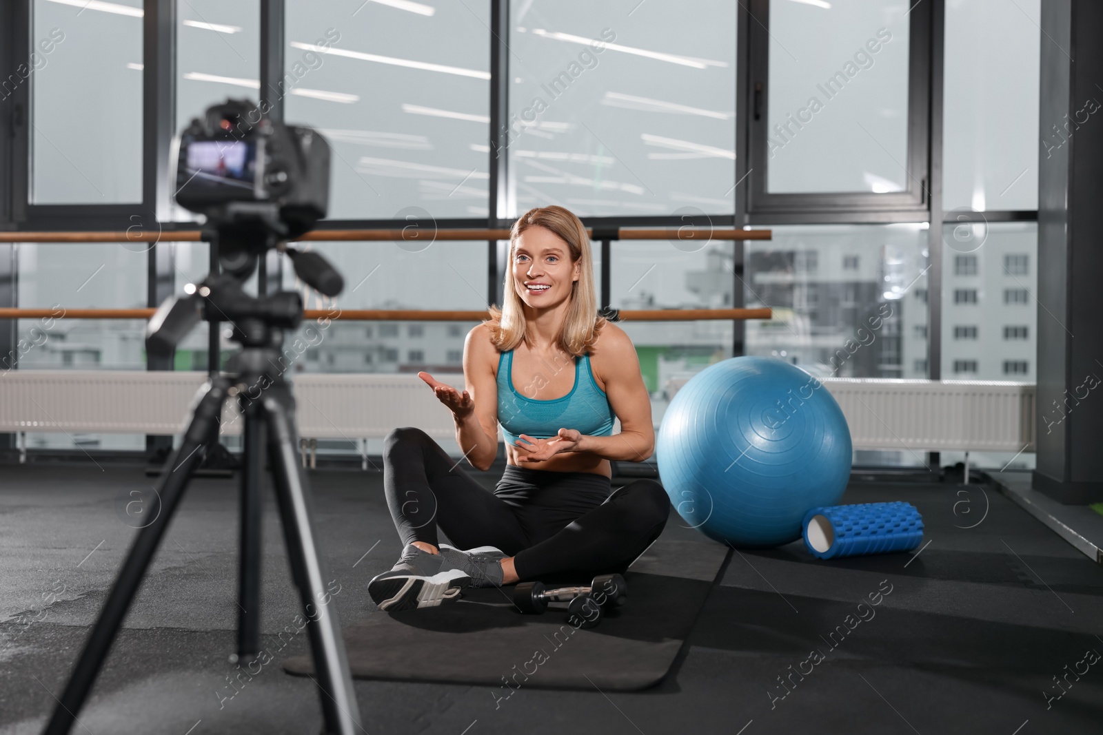 Photo of Fitness trainer recording online classes in gym