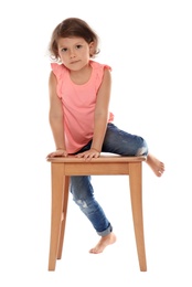 Photo of Little girl on stool against white background. Danger at home