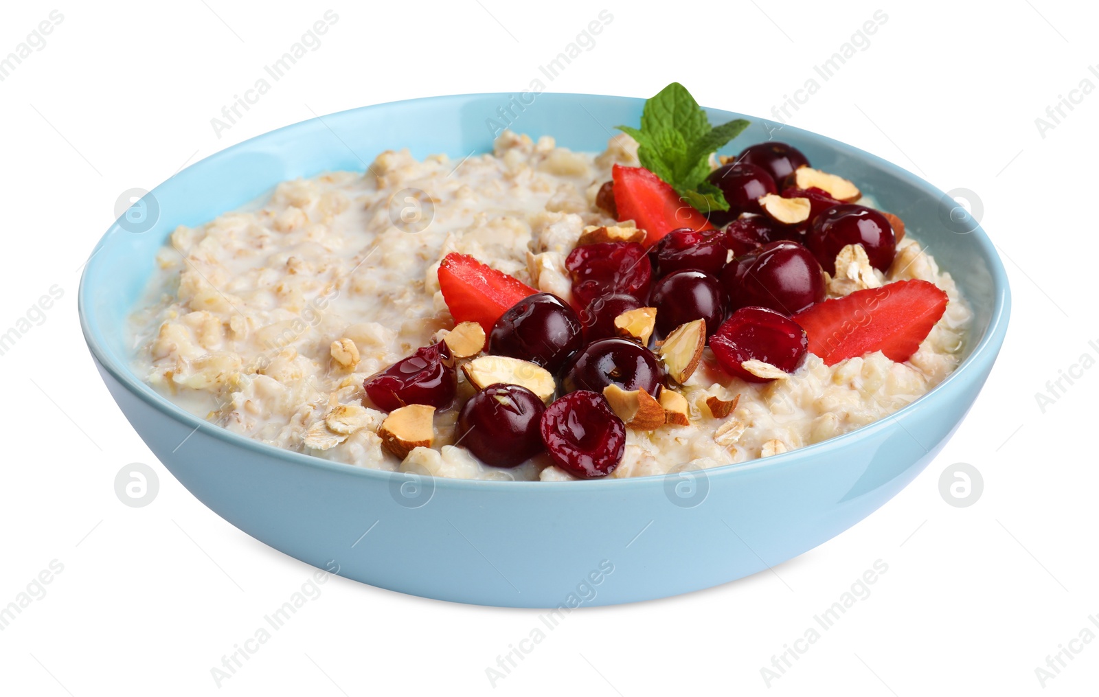 Photo of Bowl of oatmeal porridge with berries isolated on white