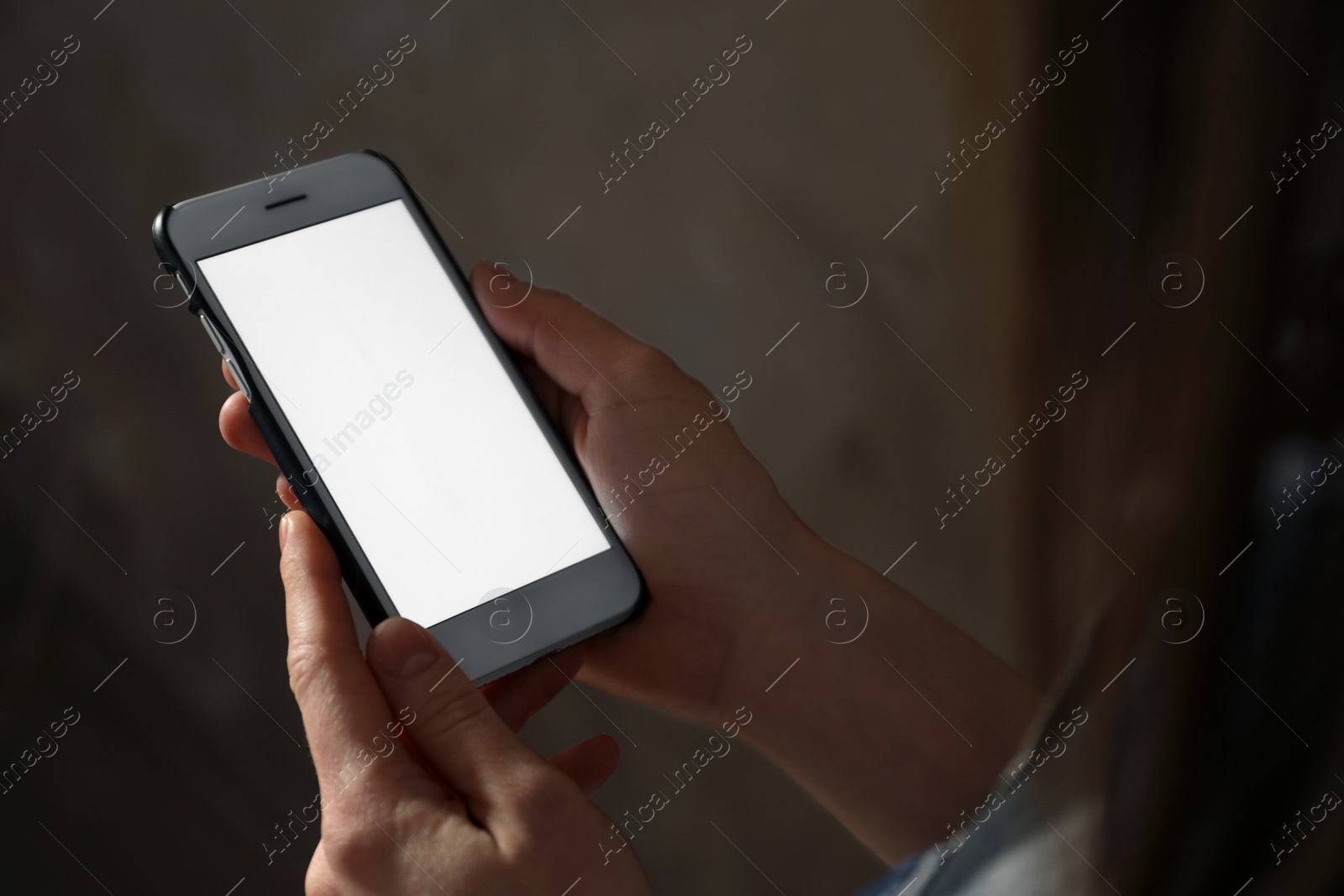 Photo of Woman using smartphone in dark room, closeup with space for text. Loneliness concept