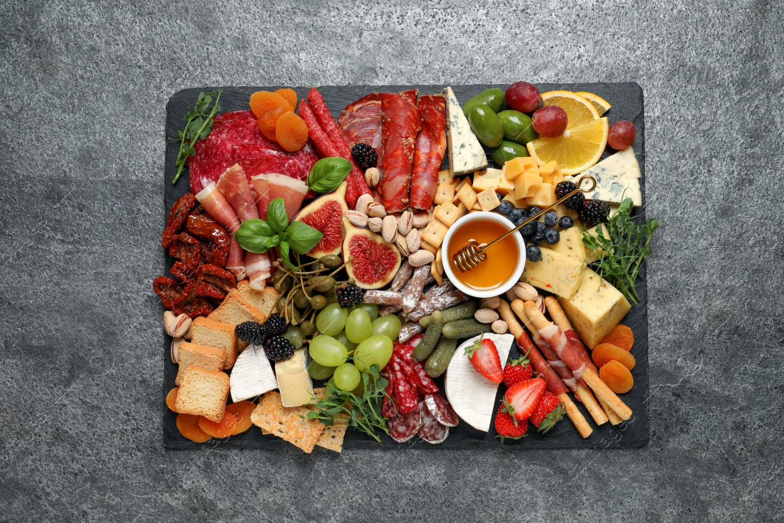 Photo of Set of different delicious appetizers served on grey table, top view