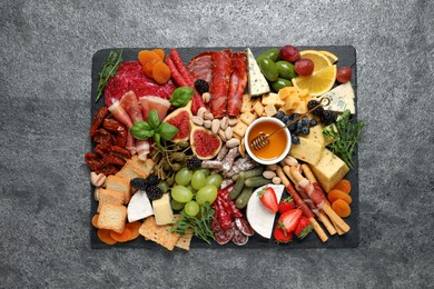 Set of different delicious appetizers served on grey table, top view
