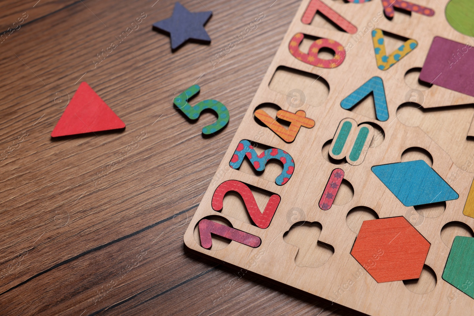 Photo of Math game kit for children on wooden table, closeup
