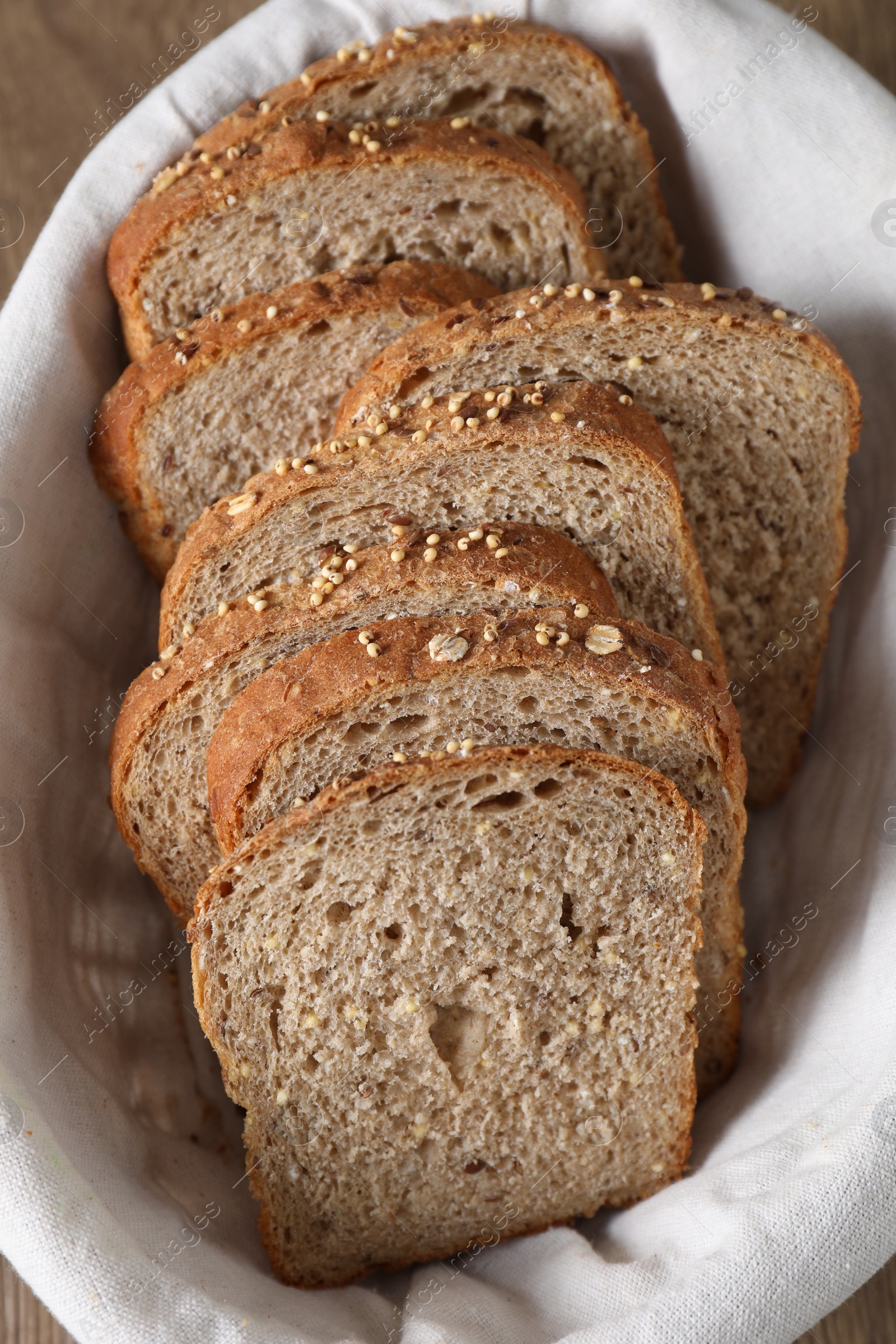 Photo of Slices of fresh bread in basket on table, above view