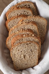 Photo of Slices of fresh bread in basket on table, above view