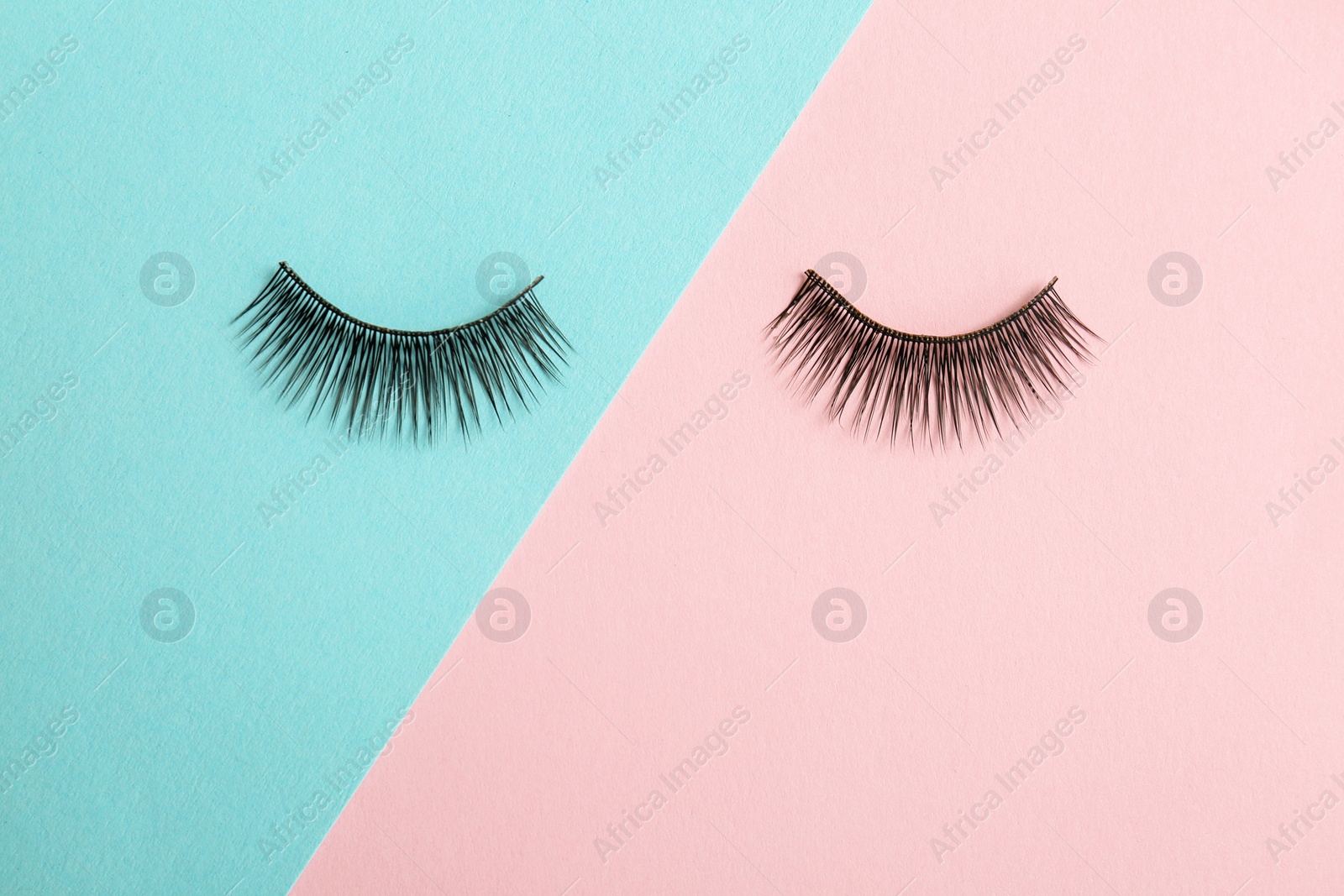 Photo of False eyelashes on color background