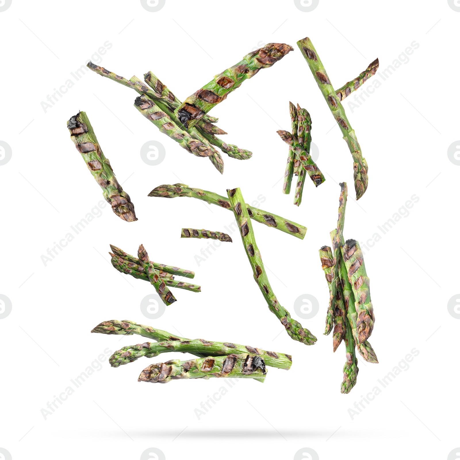 Image of Grilled asparagus spears in air on white background