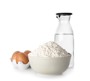 Photo of Wheat flour, eggs and bottle of water on white background