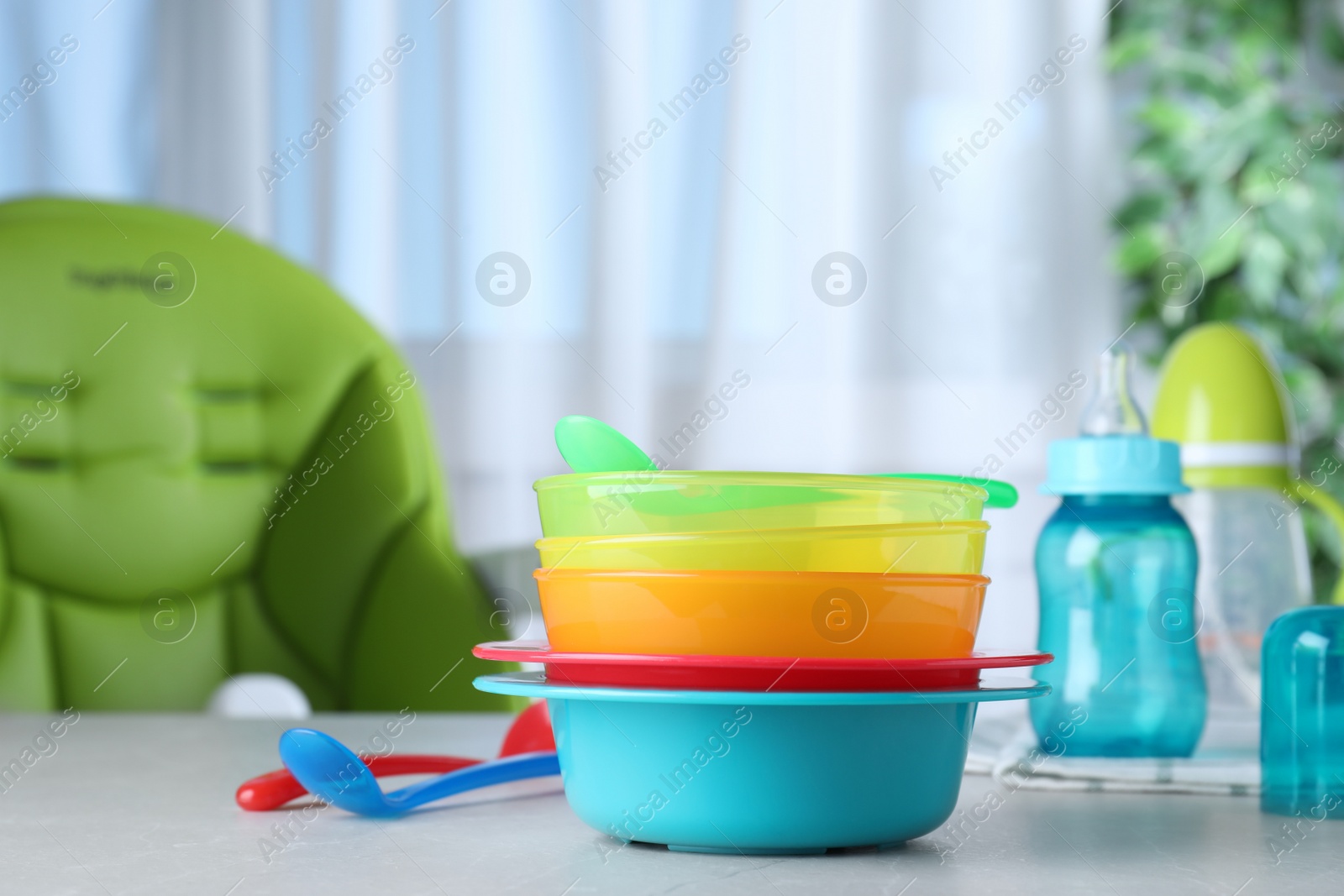 Photo of Bright child's dishware on grey table indoors