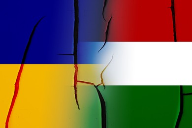 Image of Flags of Ukraine and Hungary on broken wall. International diplomatic relationships