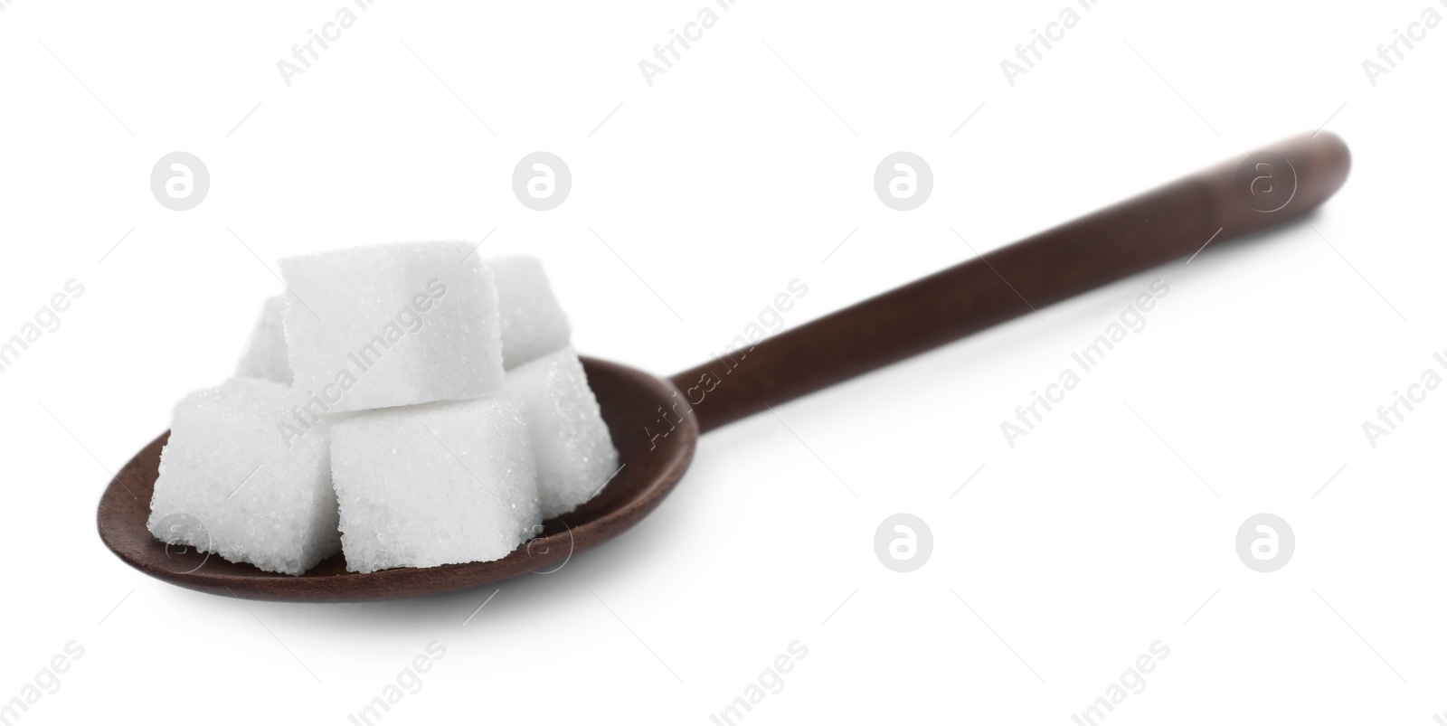 Photo of Refined sugar cubes in wooden spoon isolated on white