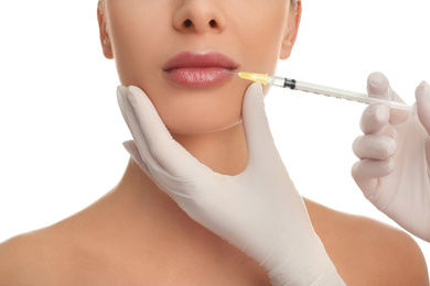 Photo of Woman getting lip injection on white background, closeup