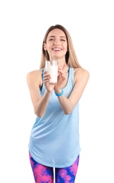 Beautiful young woman in sportswear drinking milk on white background