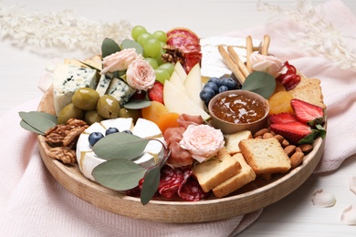 Photo of Assorted appetizer served on white wooden background