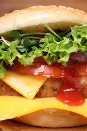 Photo of Delicious burger with tofu, fresh vegetables and sauce on table, closeup