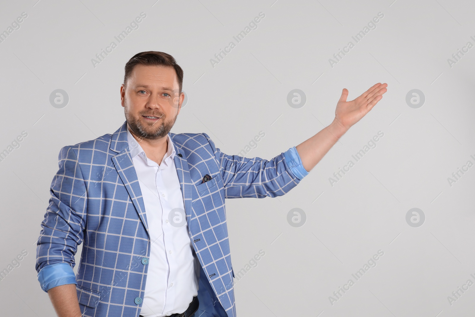 Photo of Portrait of mature man on light grey background