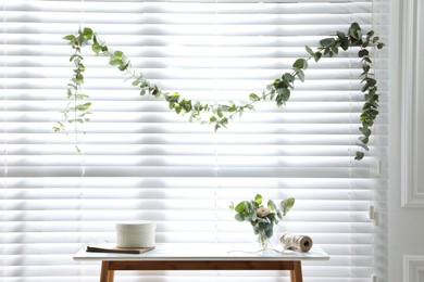 Photo of Stylish room decorated with beautiful eucalyptus garland