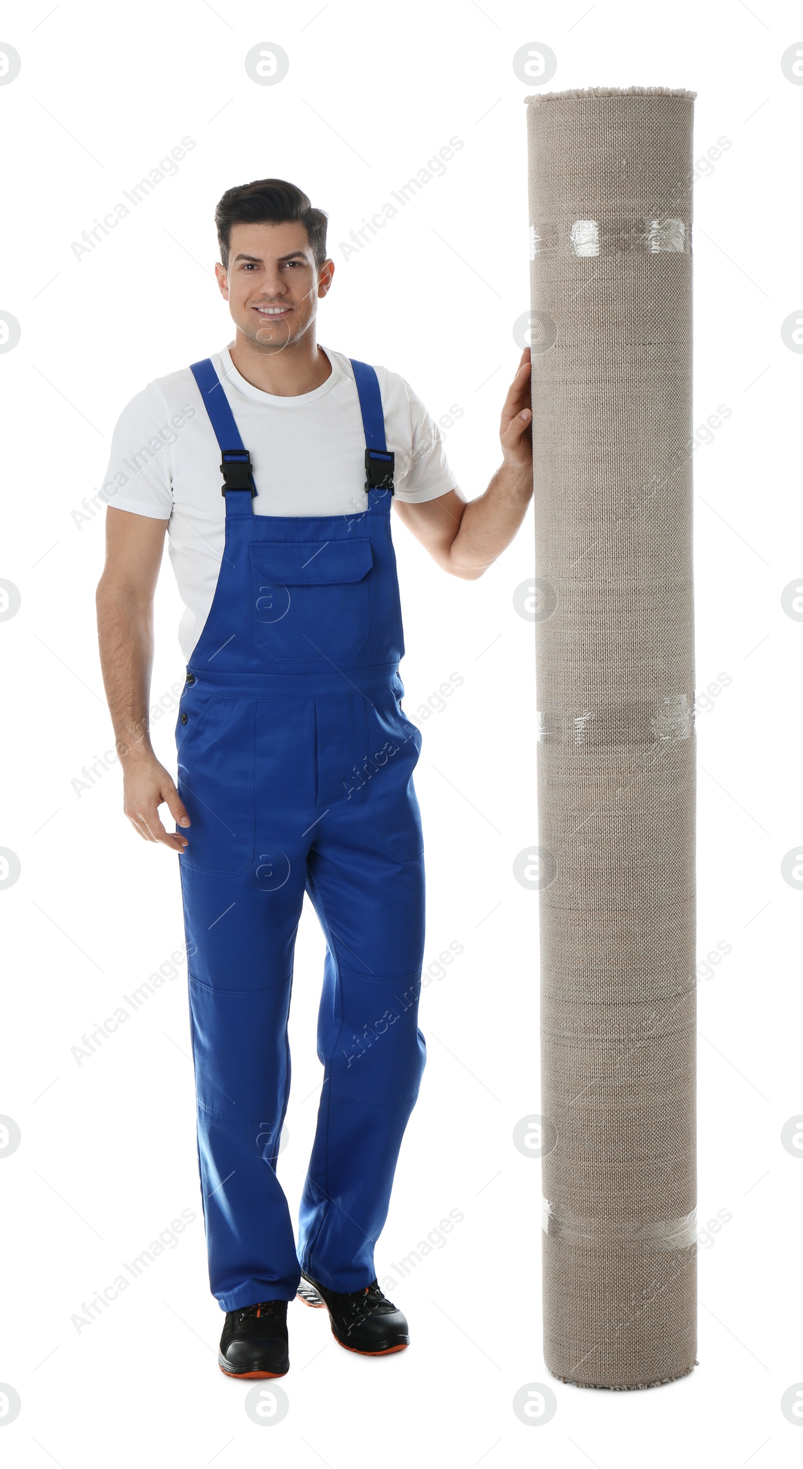 Photo of Male worker with rolled carpet on white background