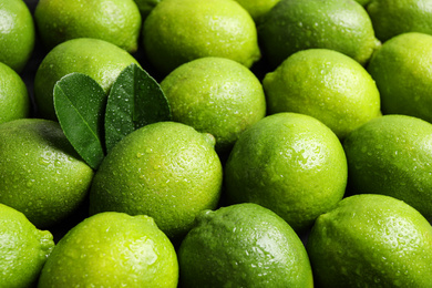 Photo of Fresh ripe juicy limes as background, closeup