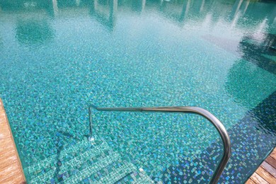 Photo of Outdoor swimming pool with steps and rail at resort