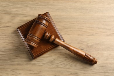 Photo of Wooden gavel and sound block on table, top view