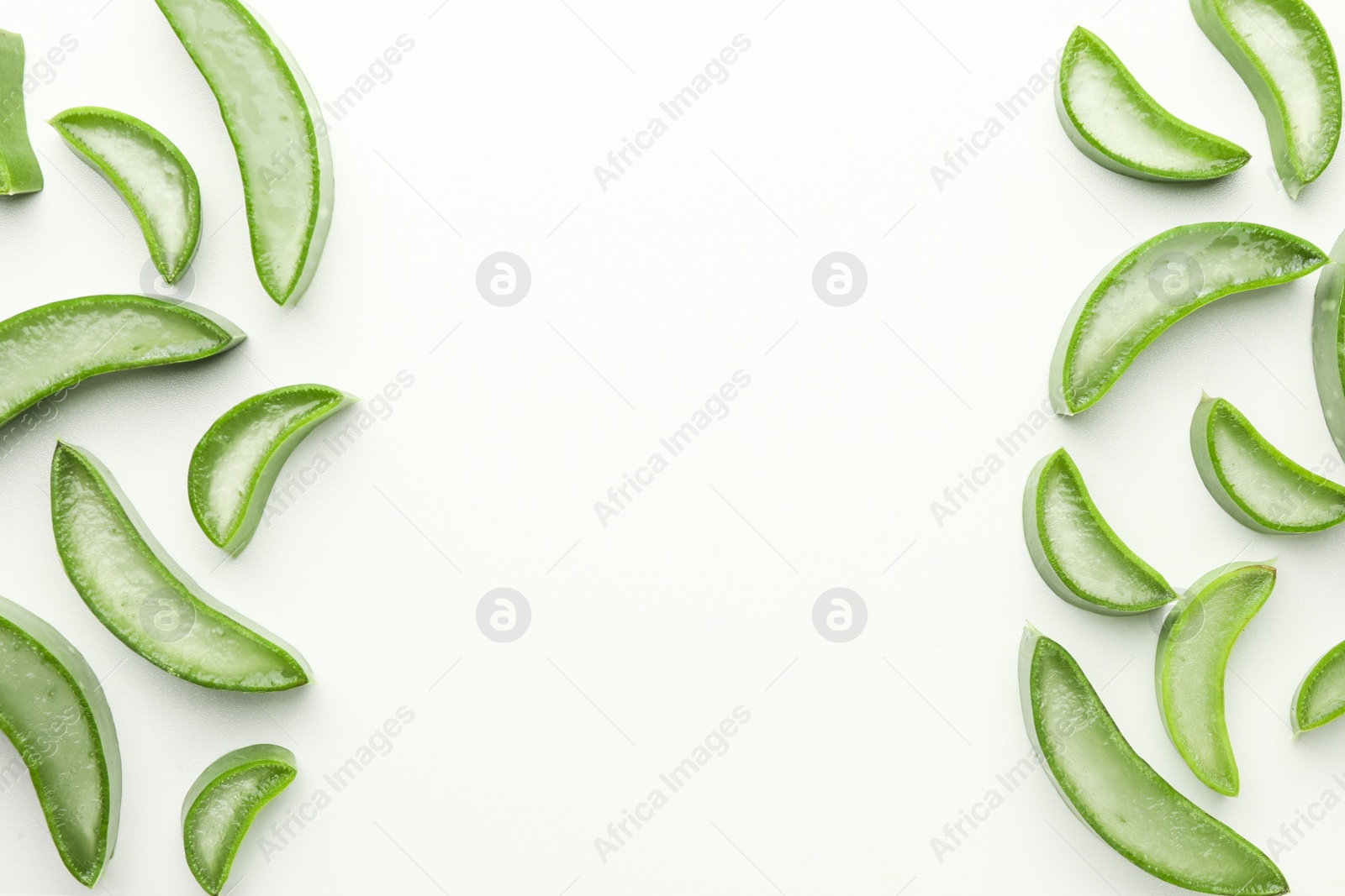 Photo of Fresh aloe vera slices on white background, flat lay. Space for text