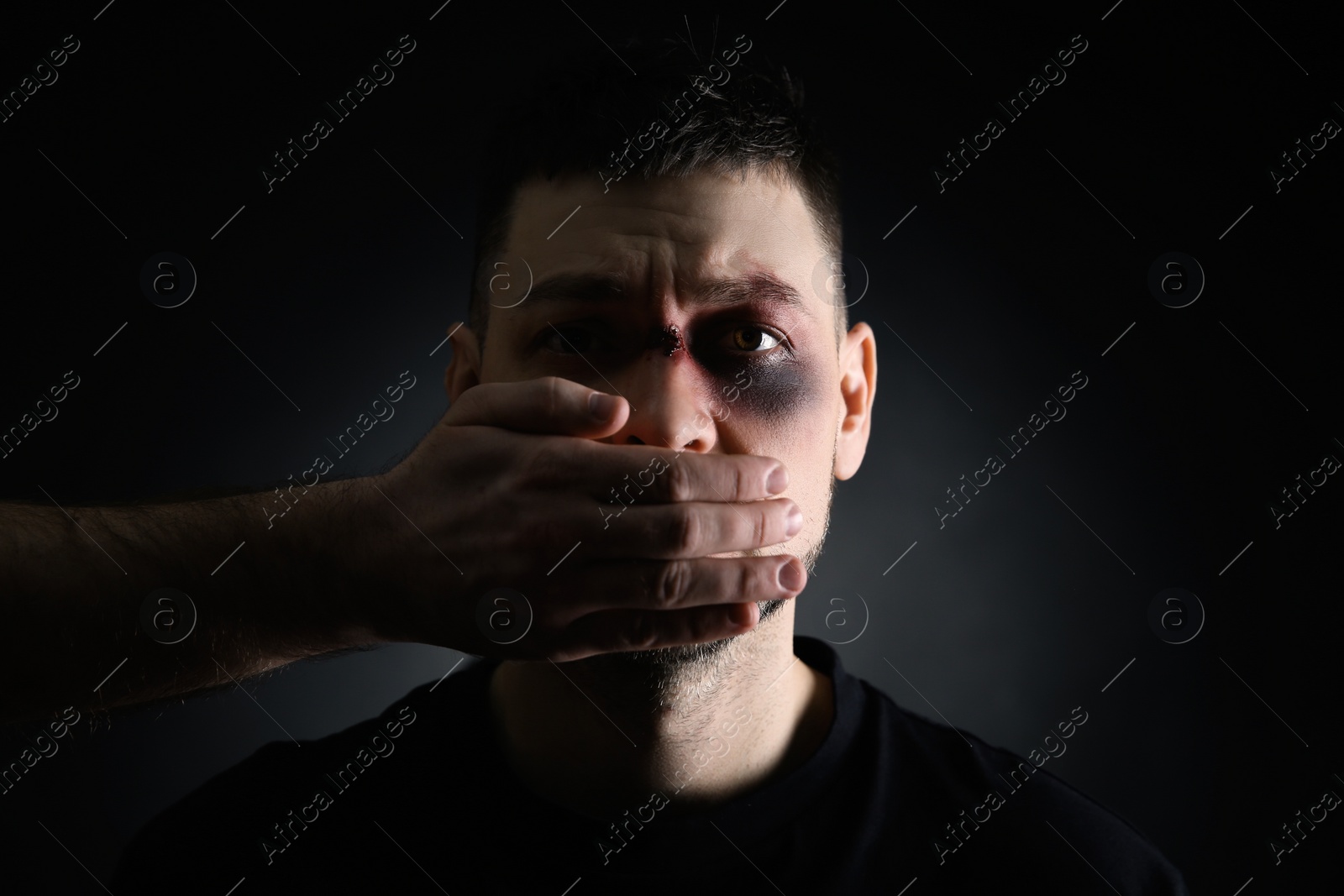 Photo of Person abusing adult man on dark background. Domestic violence