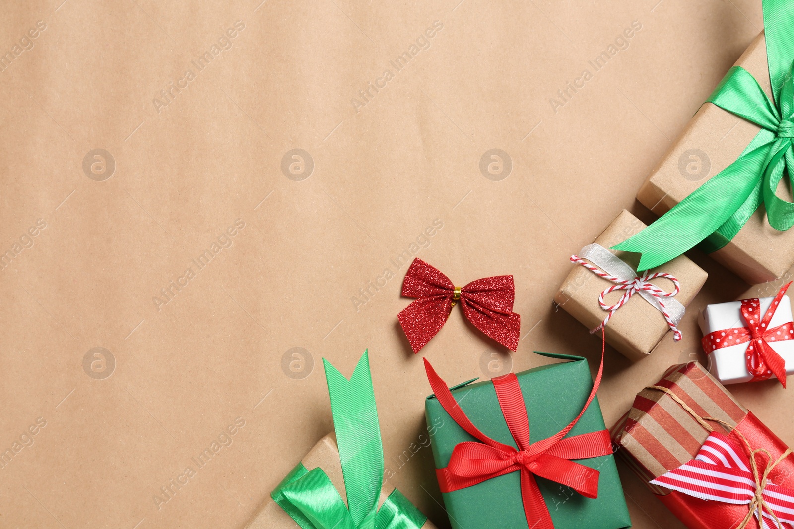 Photo of Flat lay composition with gift boxes on beige background, space for text