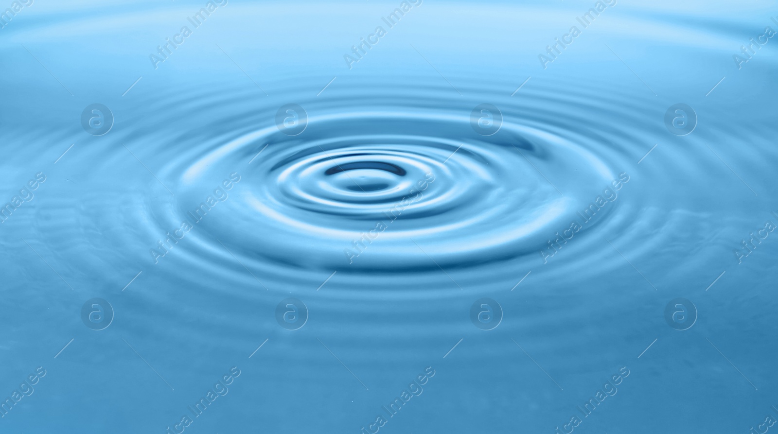 Photo of Blue water with concentric waves as background, closeup