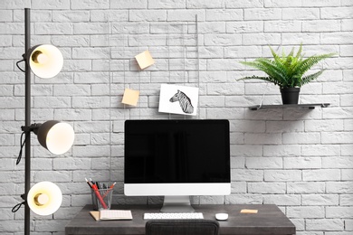 Photo of Comfortable workplace with computer on desk in home office