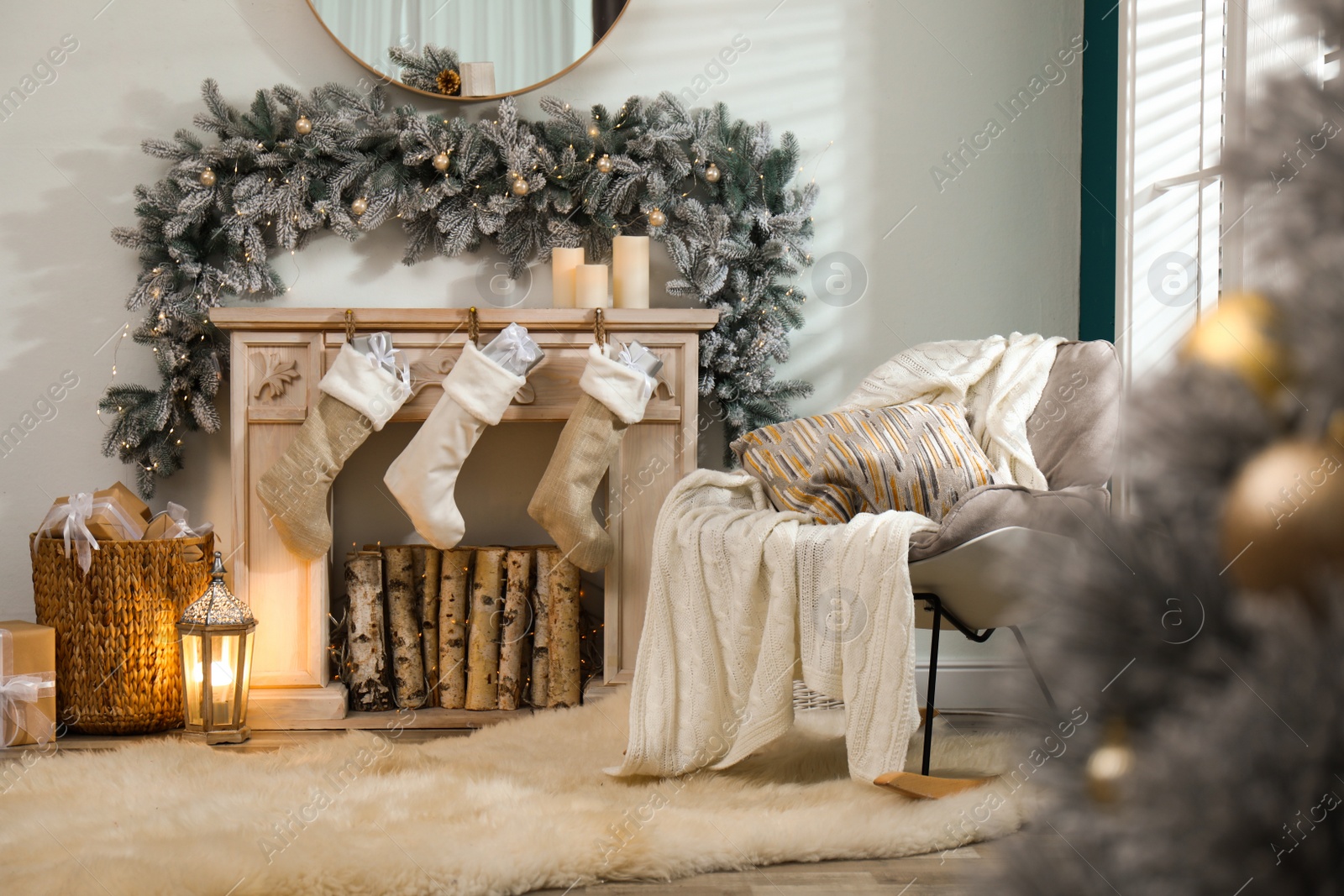 Photo of Fireplace with Christmas stockings in festive room interior