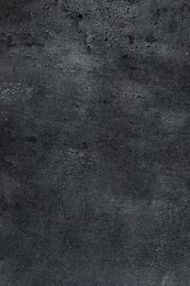 Texture of dark grey stone surface as background, closeup