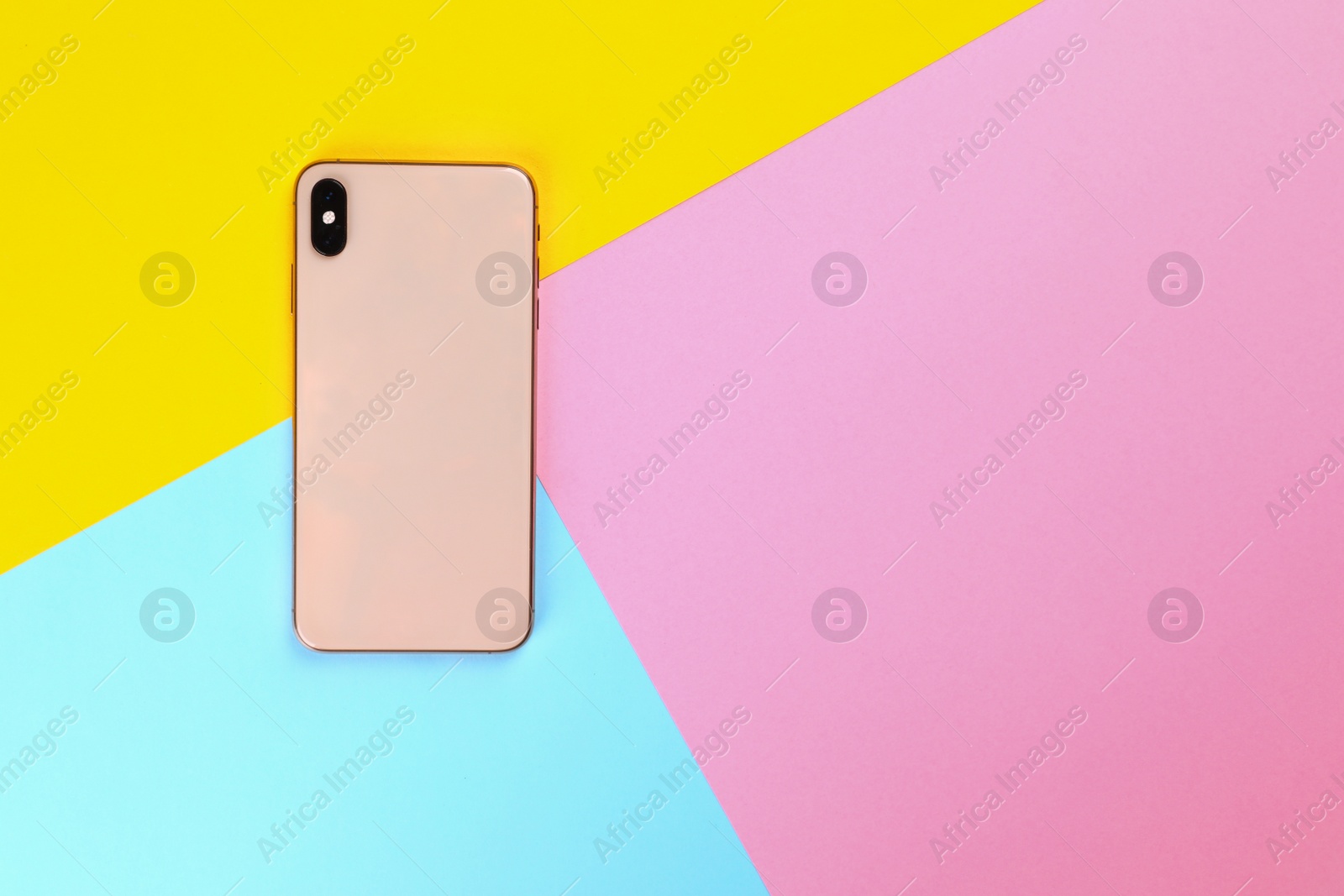 Photo of Modern smartphone on colorful background, top view. Space for text