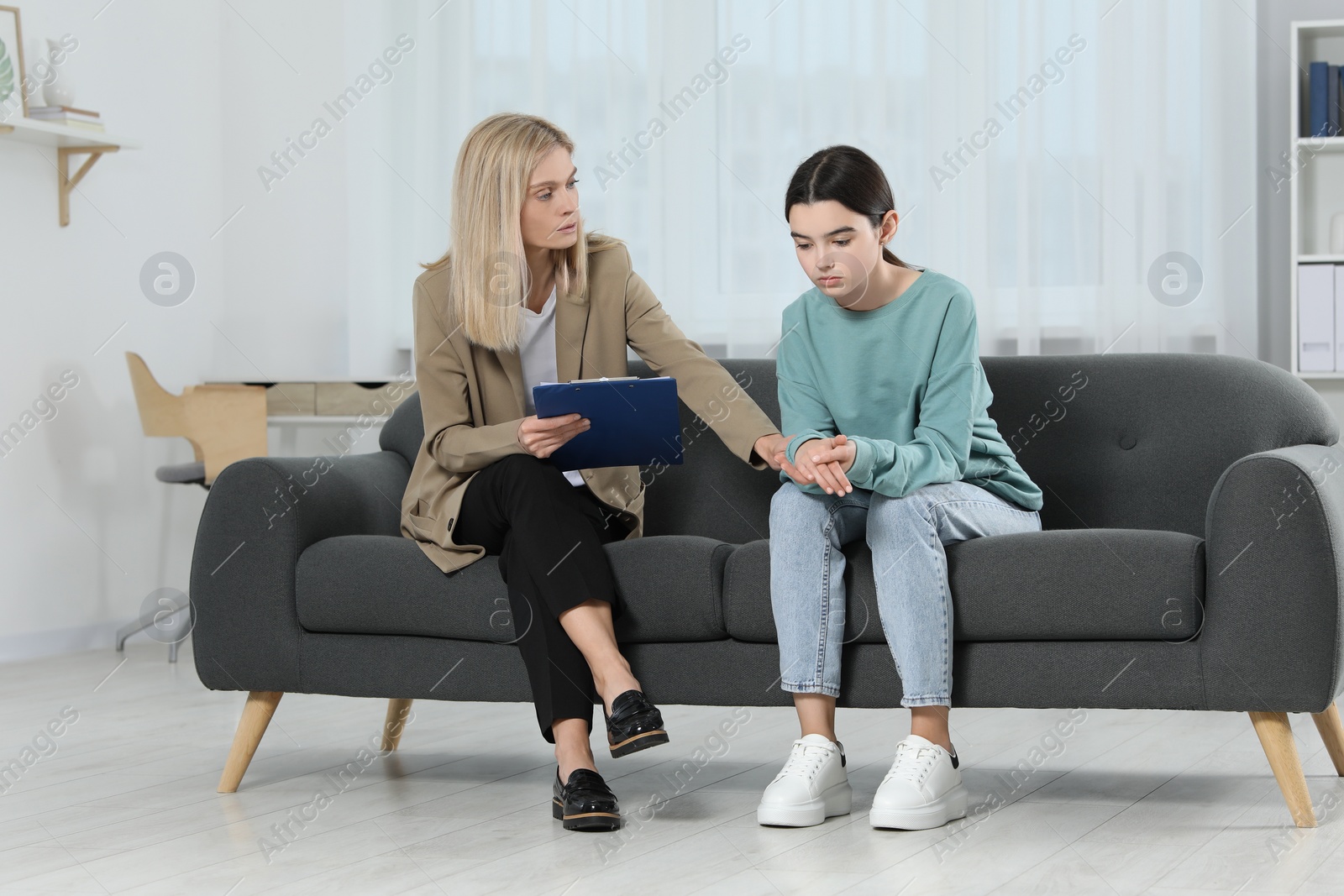 Photo of Psychologist working with teenage girl in office. Teenager problems