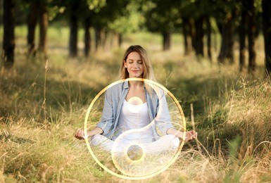 Image of Young woman meditating in forest. Yin and yang symbol