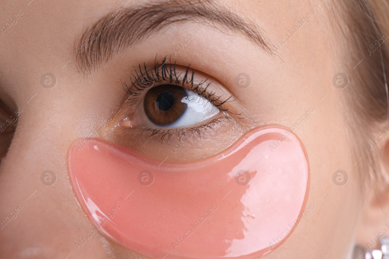 Photo of Young woman with under eye patch , closeup