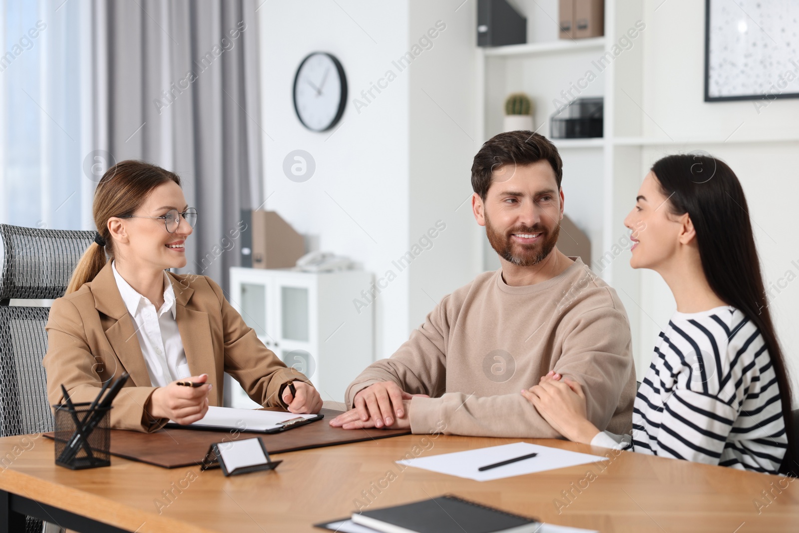 Photo of Couple having meeting with lawyer in office