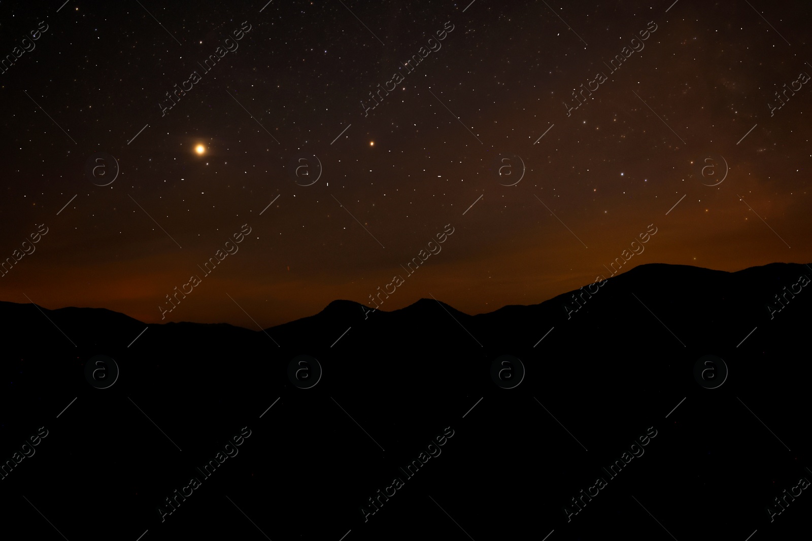 Image of Sky with twinkling stars over mountains at night