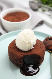 Photo of Delicious fresh fondant with hot chocolate and ice cream on plate