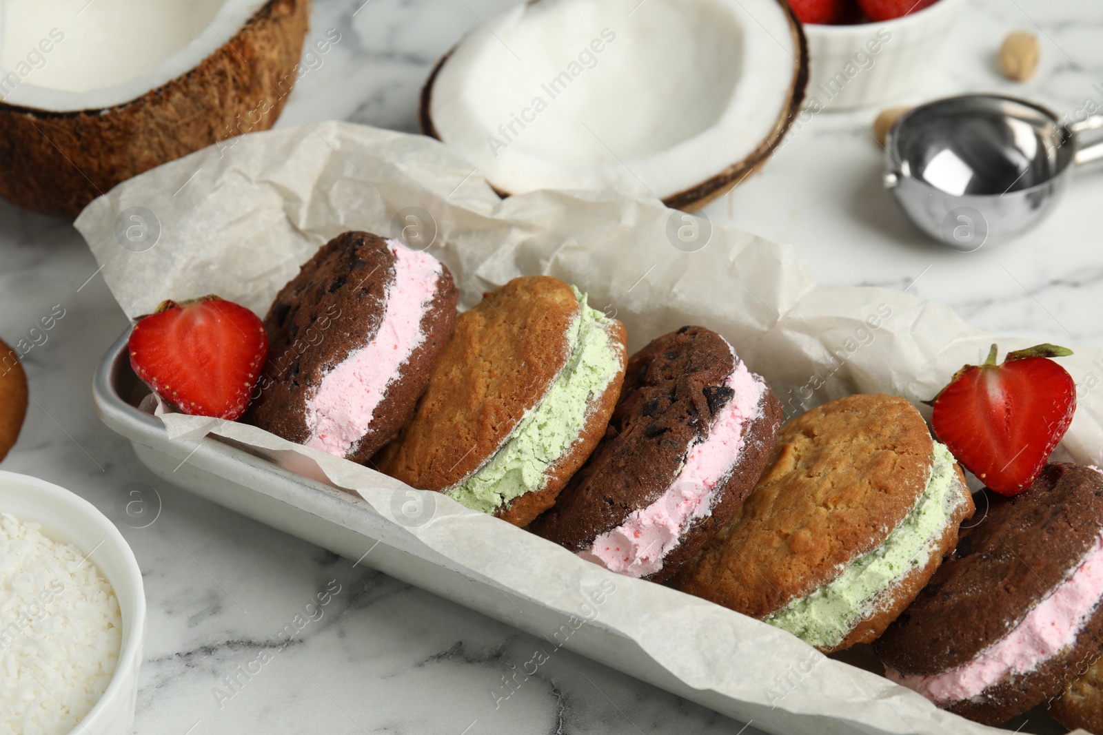 Photo of Different sweet delicious ice cream cookie sandwiches served on table